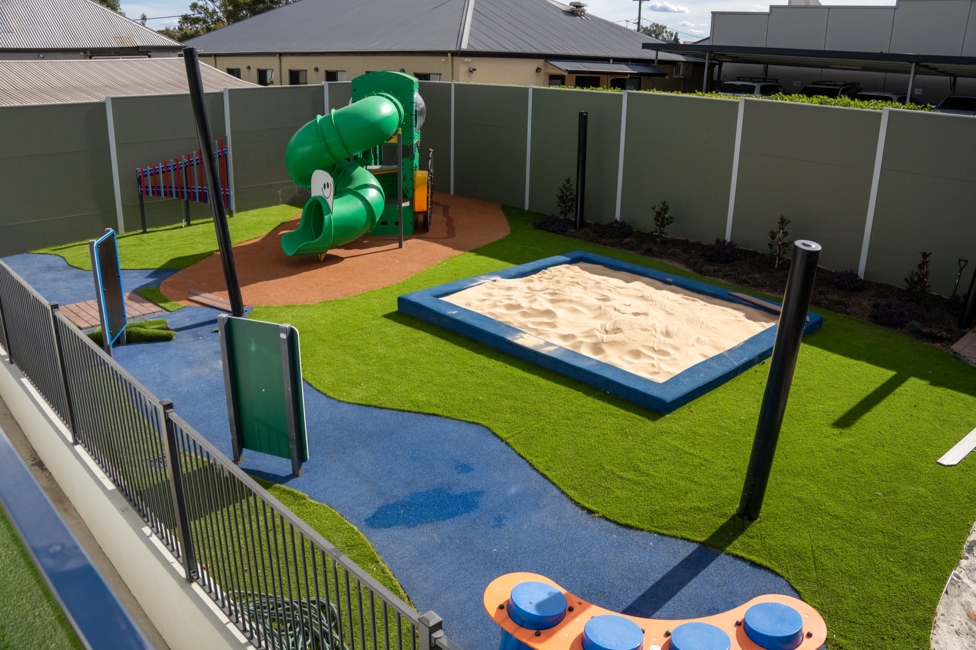Outdoor sandpit and tube slide