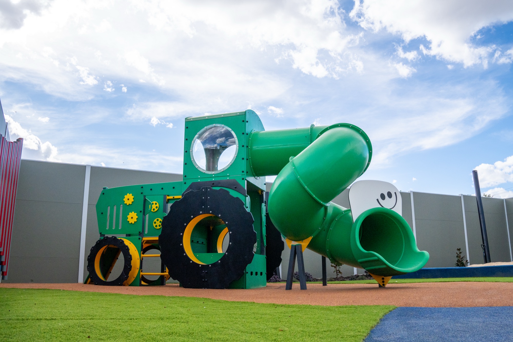 Outdoor playground with tractor slide